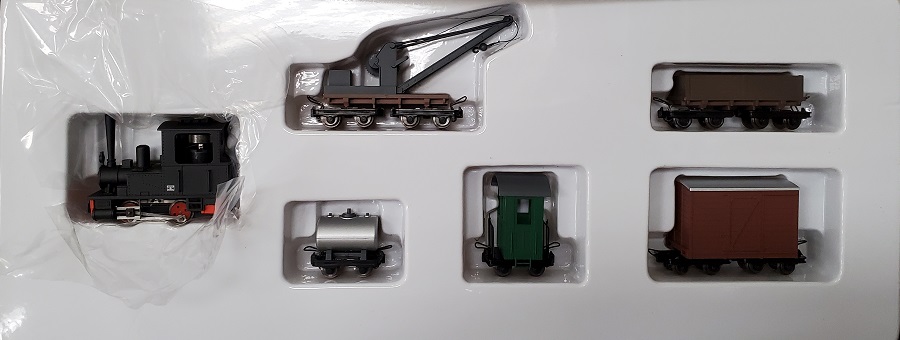 Koppel-Locomotive with straight Stack, brown
boxcar,crane , gondola, green caboose and silver tank car.